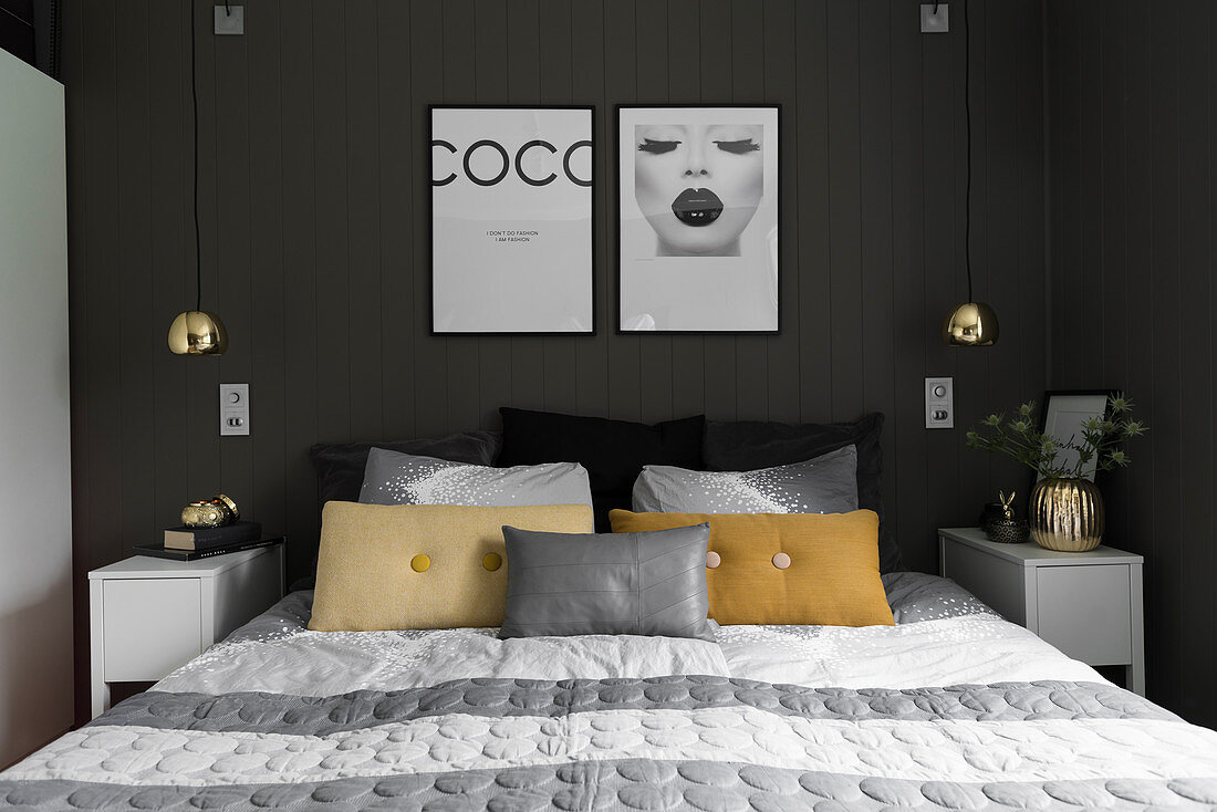 Doppelbett und Nachtkästchen im Schlafzimmer mit anthrazitfarbener Wand