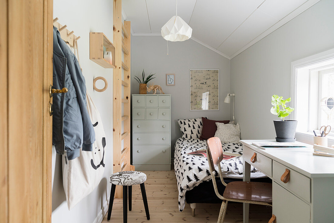 Small child's room in vintage style with sloping ceiling