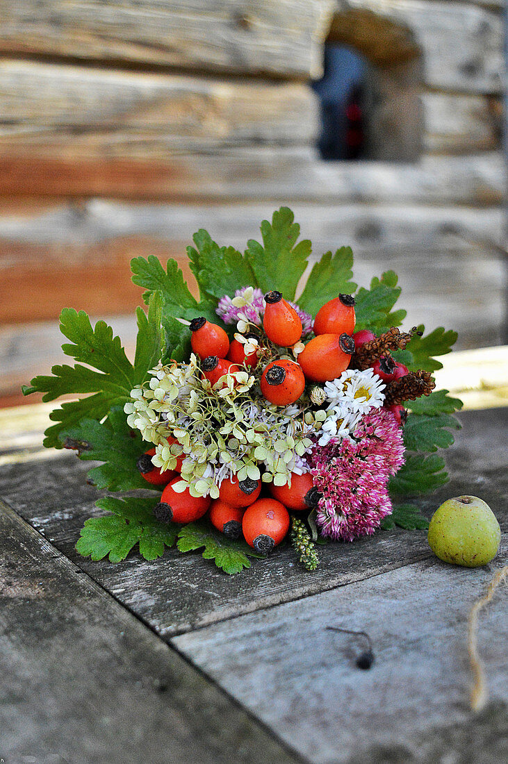 Autumn Bouquet With Rose Hips, Hydrangea And Stonecrop In Leaf Cuff