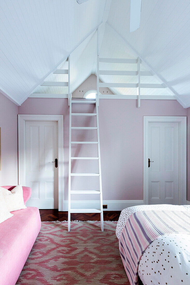 Girl's room in pink and white with ladder to the gallery under the roof