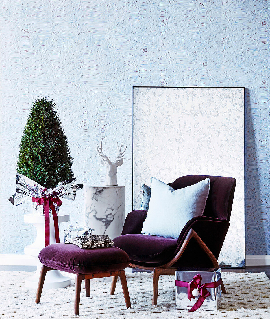 Purple velvet armchair with ottoman and Christmas decoration