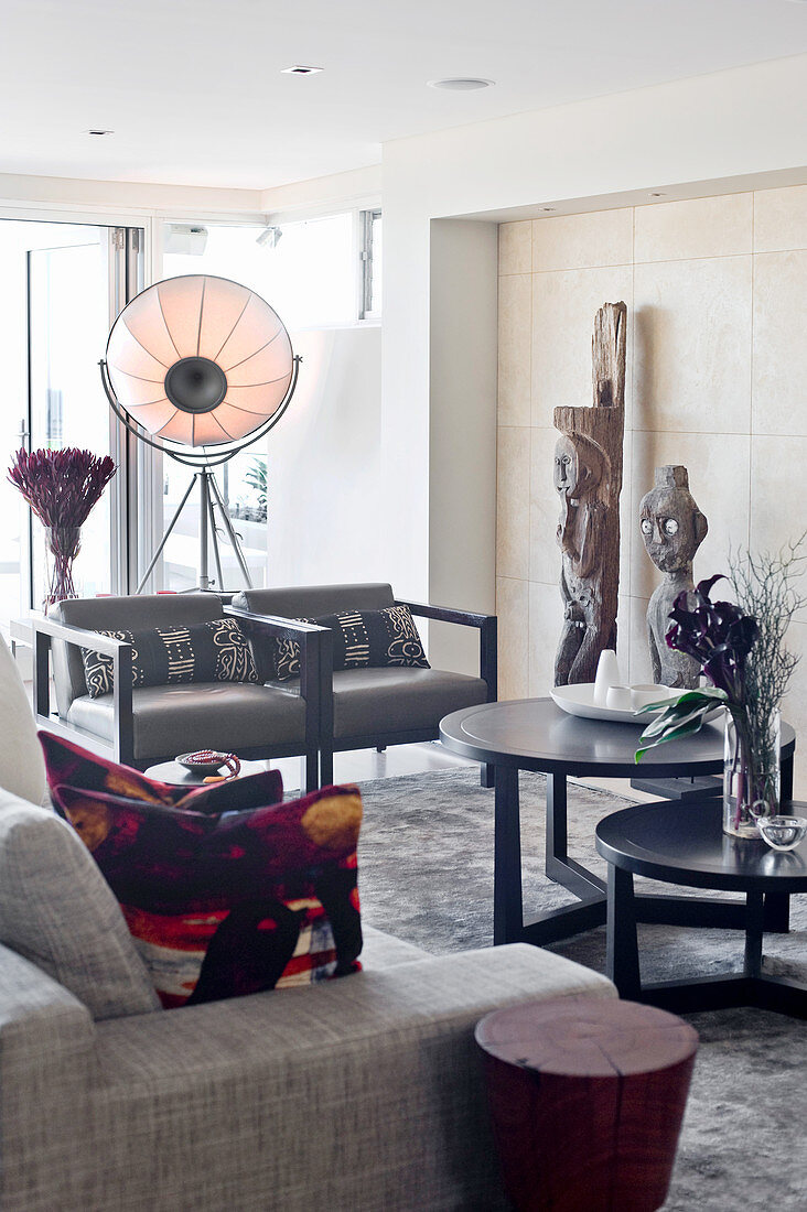 Grey sofa set, round tables, artworks and studio lamp