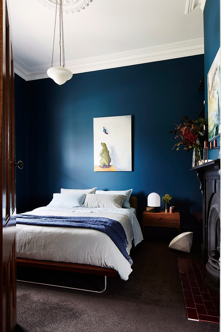 Classic bedroom with dark blue walls