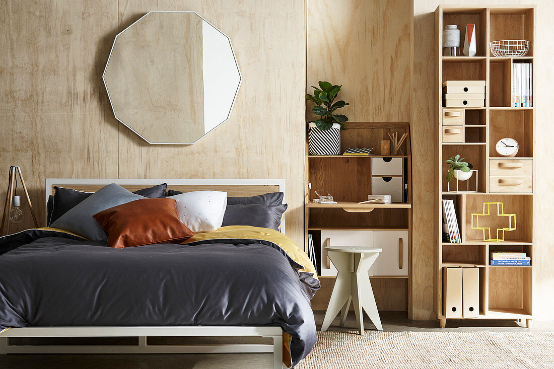 Plywood clad walls in the bedroom with home office