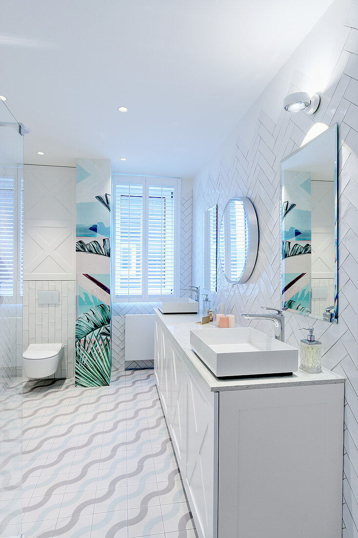 Tiles laid in herringbone pattern in white bathroom