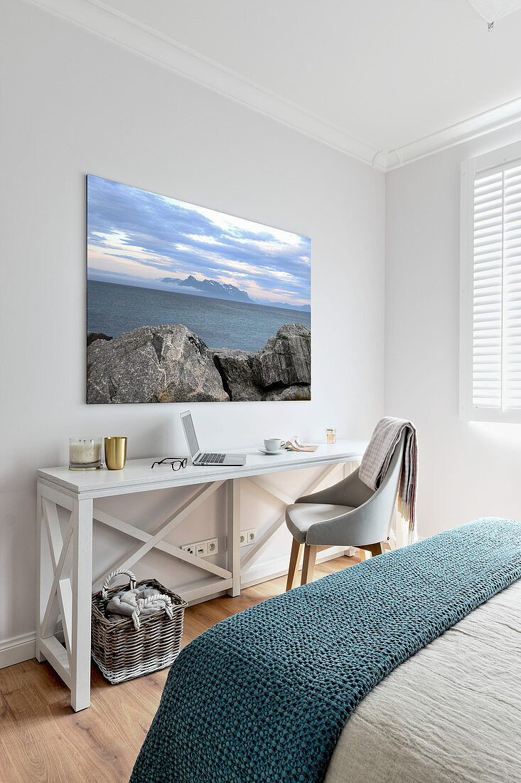 Seascape on wall above console table in bedroom