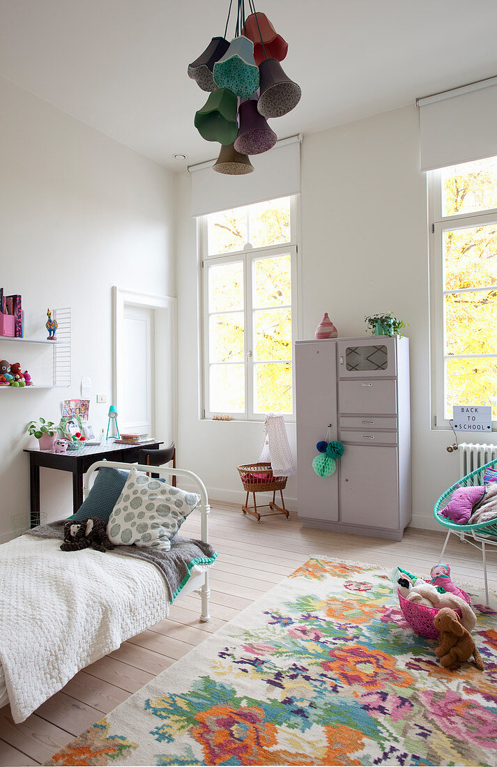 Colourful floral rug in child's bedroom with high ceiling