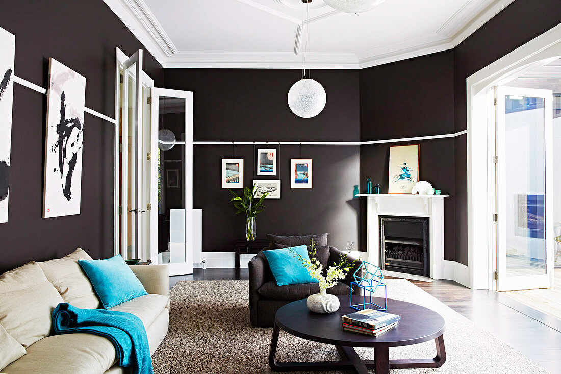 Elegantes Wohnzimmer mit schwarzen Wänden und weißer Decke, Polstermöbel und Couchtisch