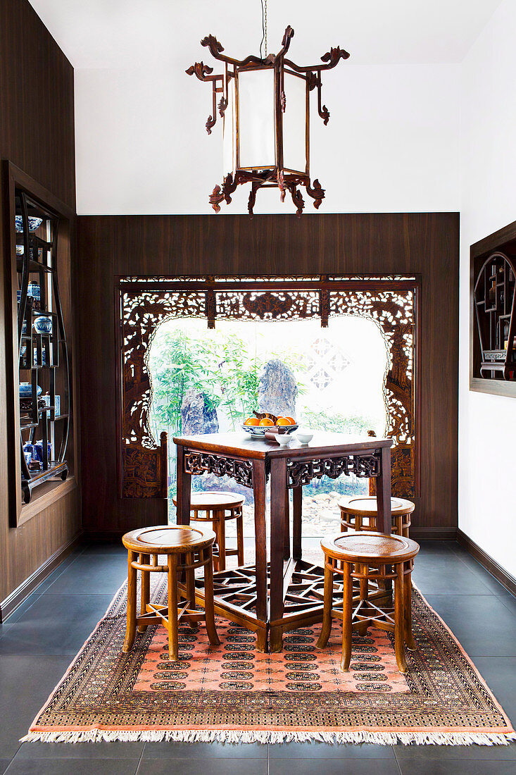 Asian tea room with antique furniture and decorative window frames