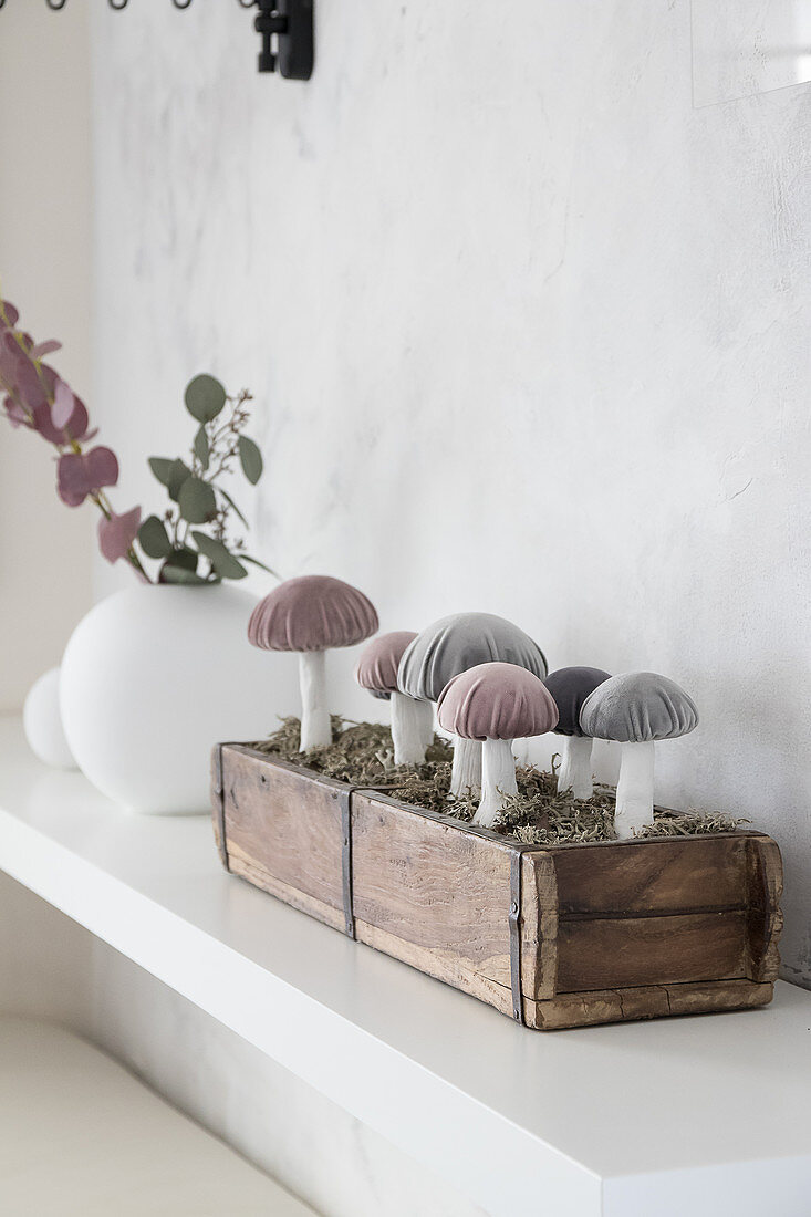 Handcrafted fabric mushrooms with velvet caps in wooden box