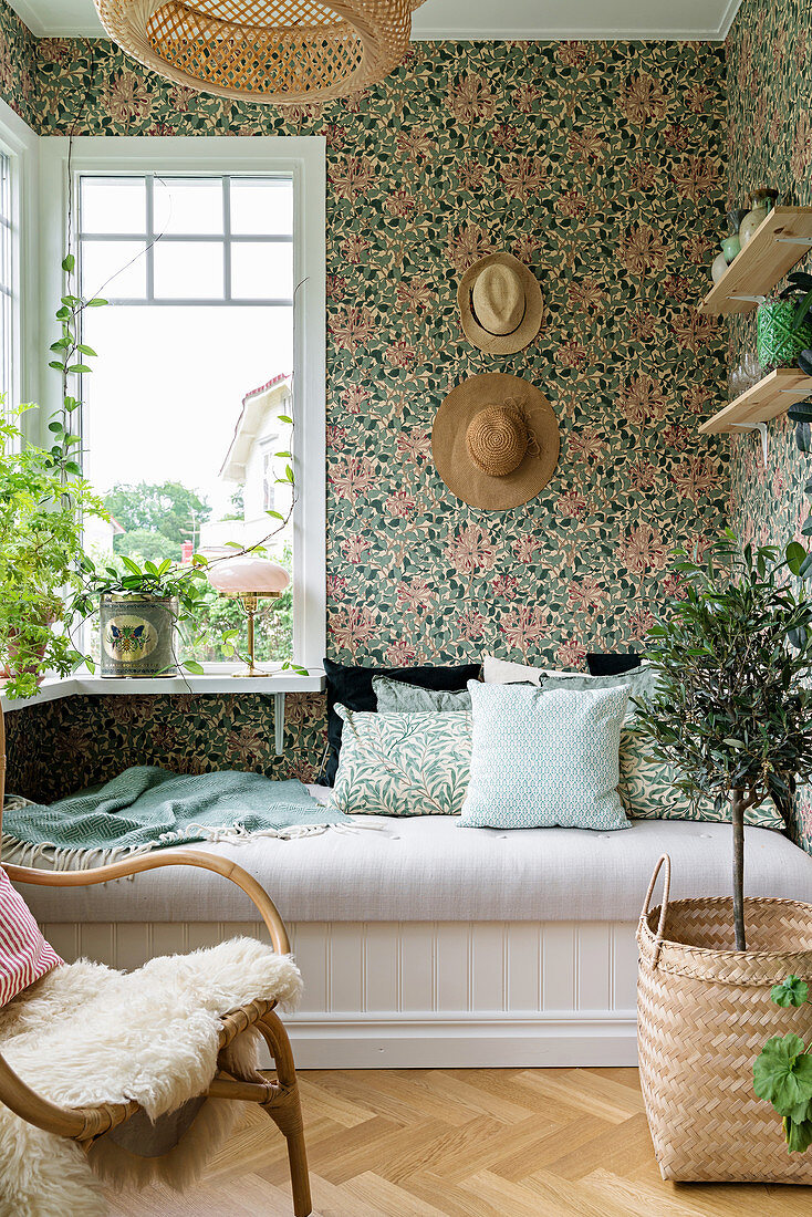 Summery conservatory with floral wallpaper and couch