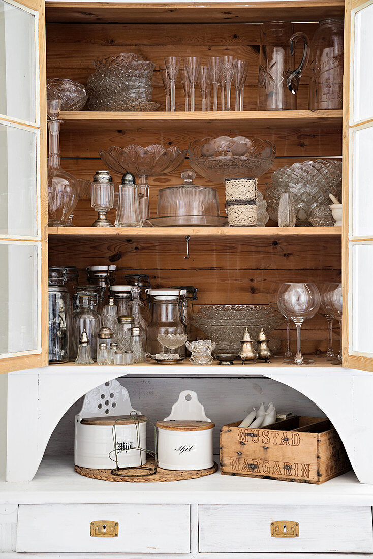 Vintage-style glassware in old, open-fronted dresser