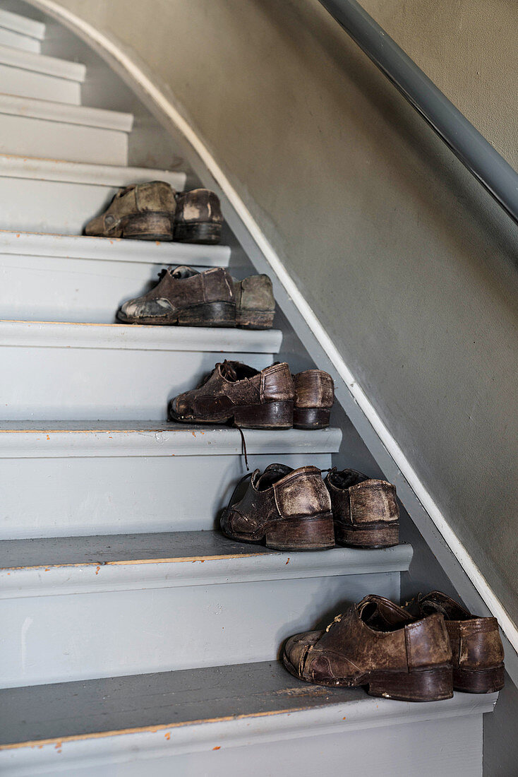 Old men's shoes on stair treads