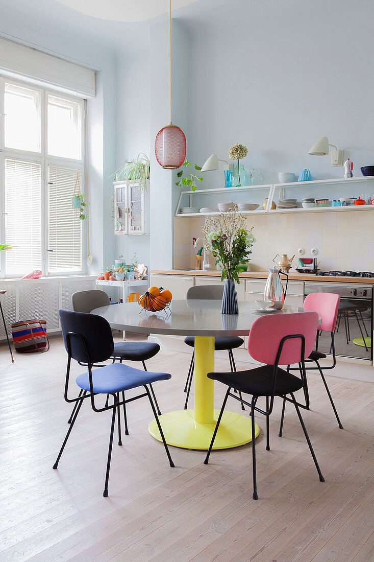 Colourful retro furniture in open-plan kitchen-dining room of period building