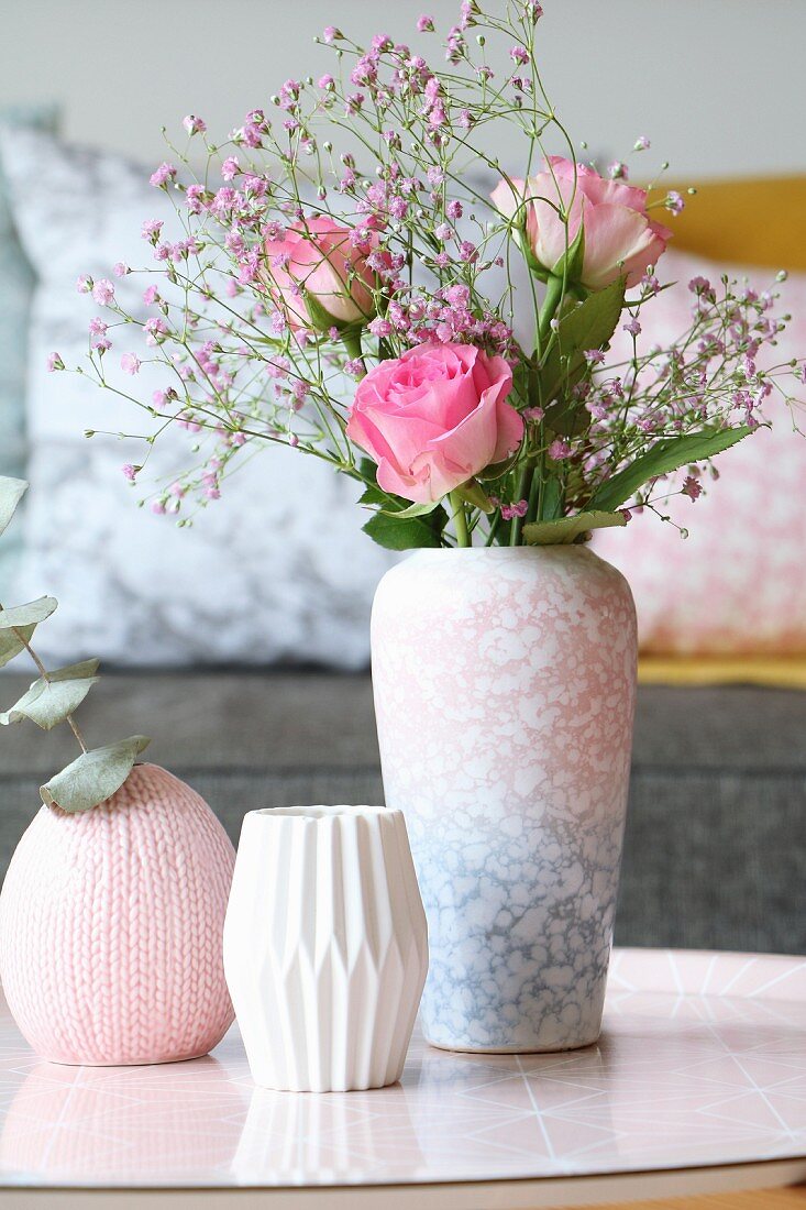 Roses and pink gypsophila in mottled vase