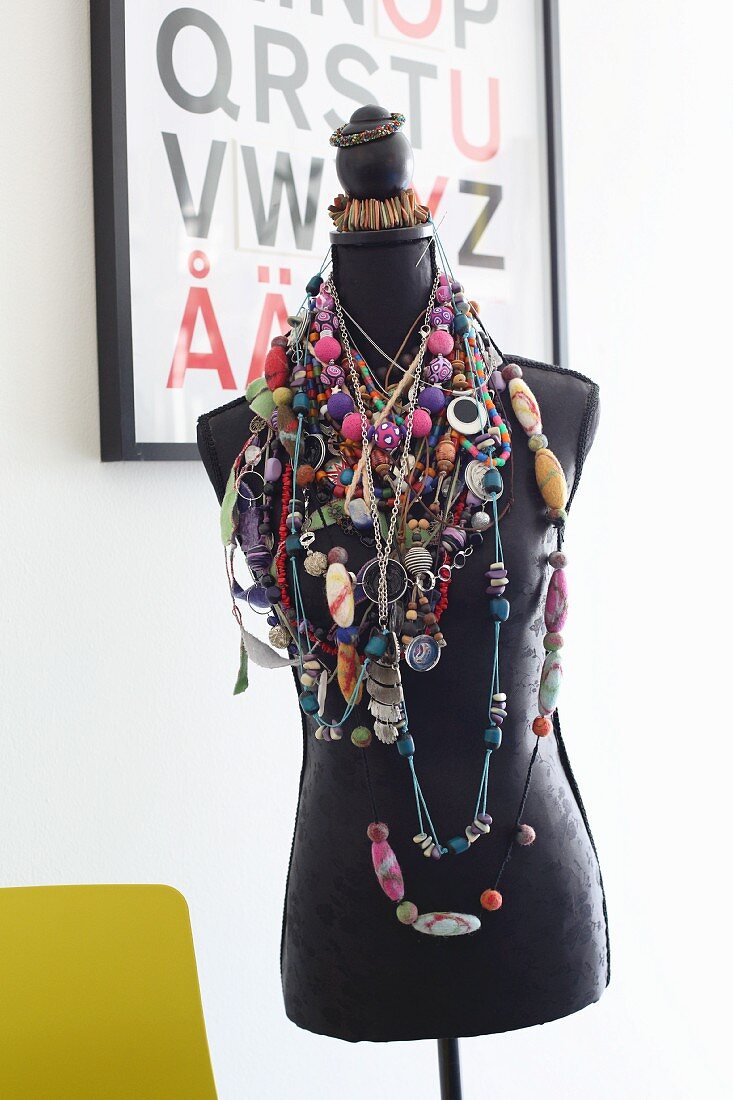 Tailors' dummy draped with many colourful necklaces