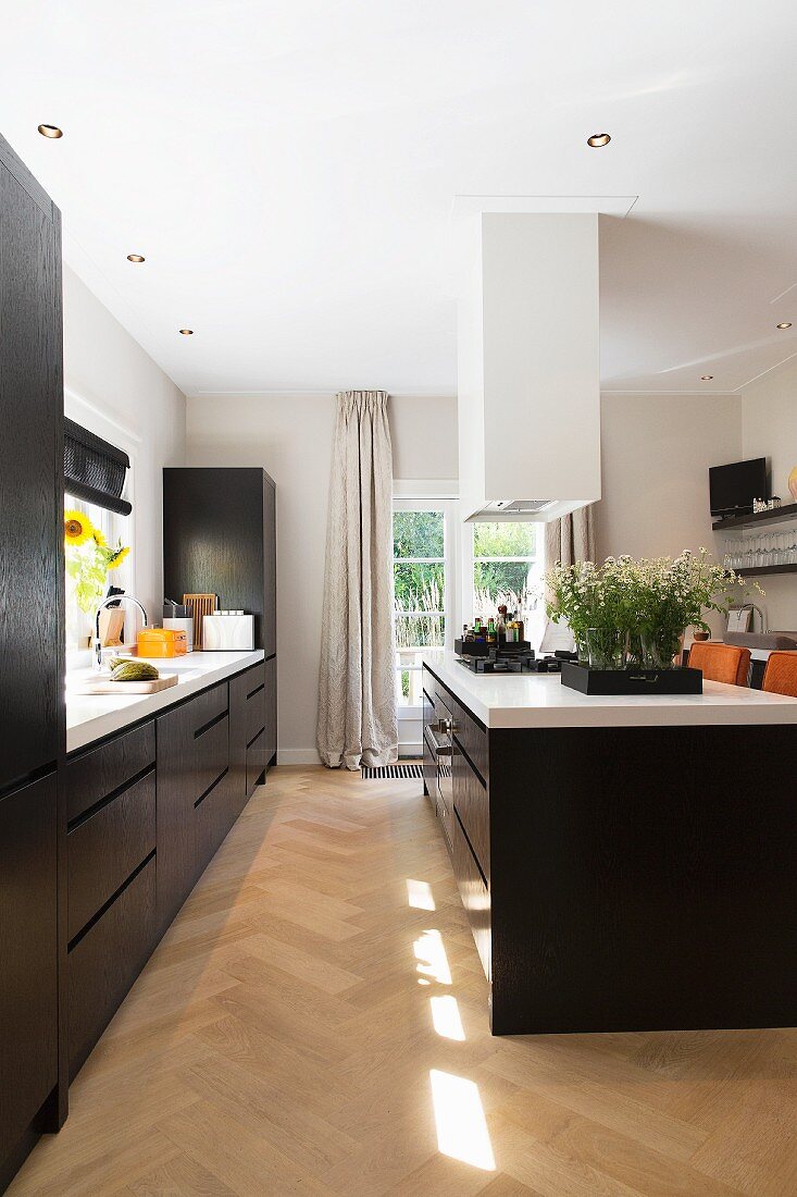 Large kitchen with black cabinets and white worksurface