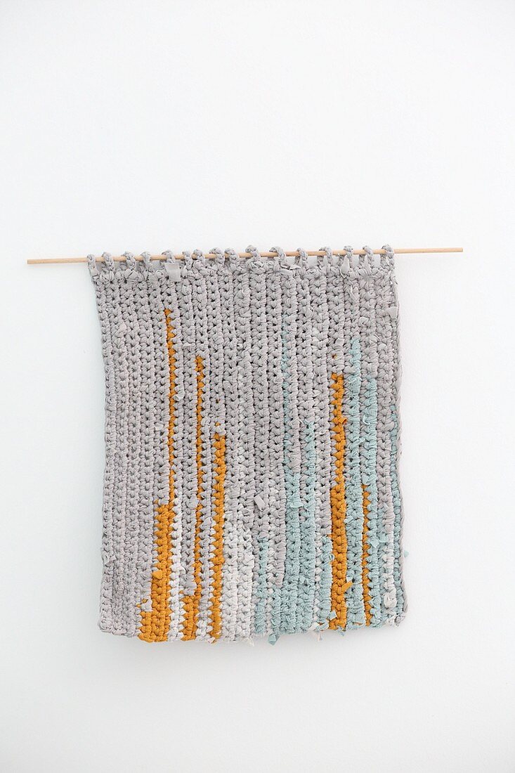Striped wall-hanging made from recycled T-shirt yarn