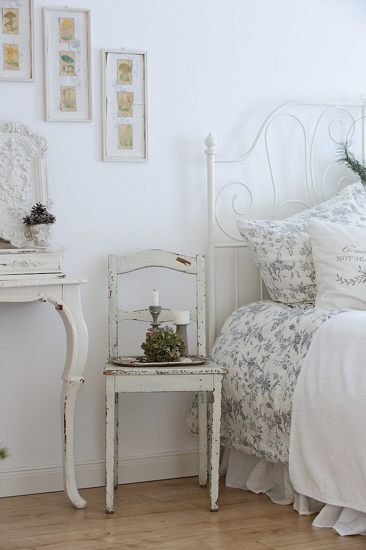 Ornate metal bed in white, vintage-style bedroom