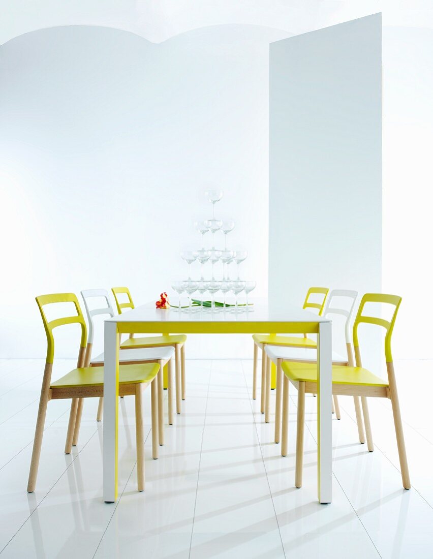 Modern dining area with neon furniture and pyramid of glasses