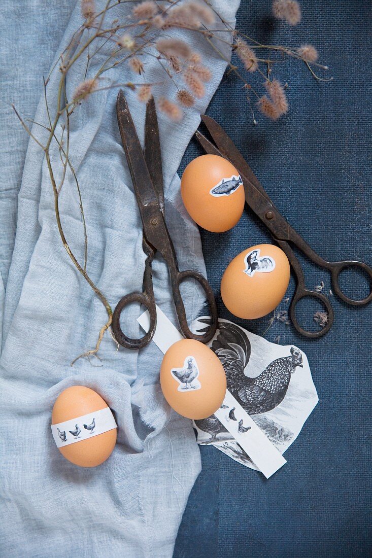 Vintage scissors and Easter eggs decorated with animal stickers