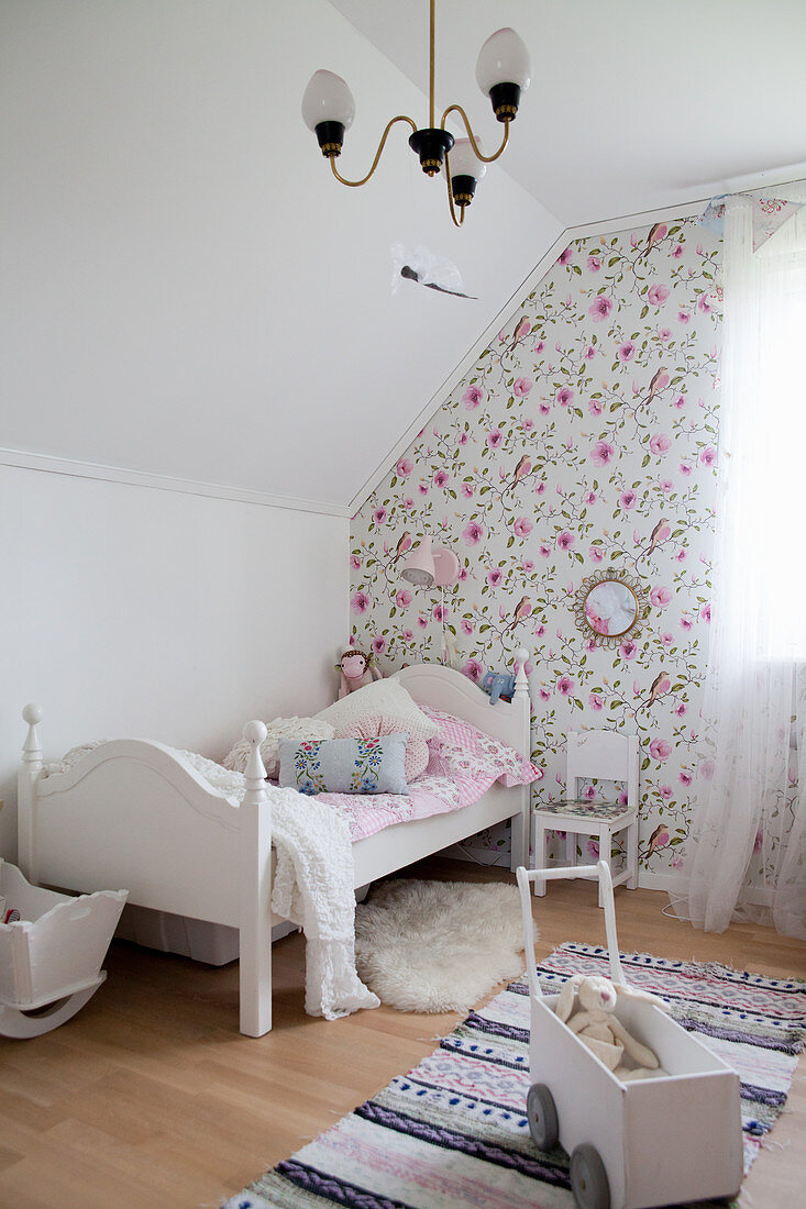 Charming girl's bedroom with bed under sloping ceiling