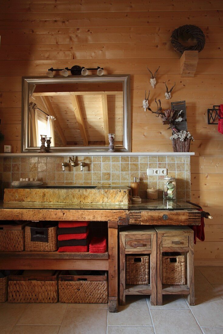 Rustic bathroom with stone sink in wooden cabin