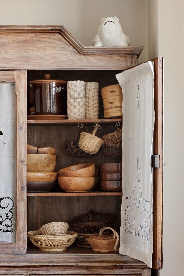 Wooden bowls in an vintage kitchen cupboard