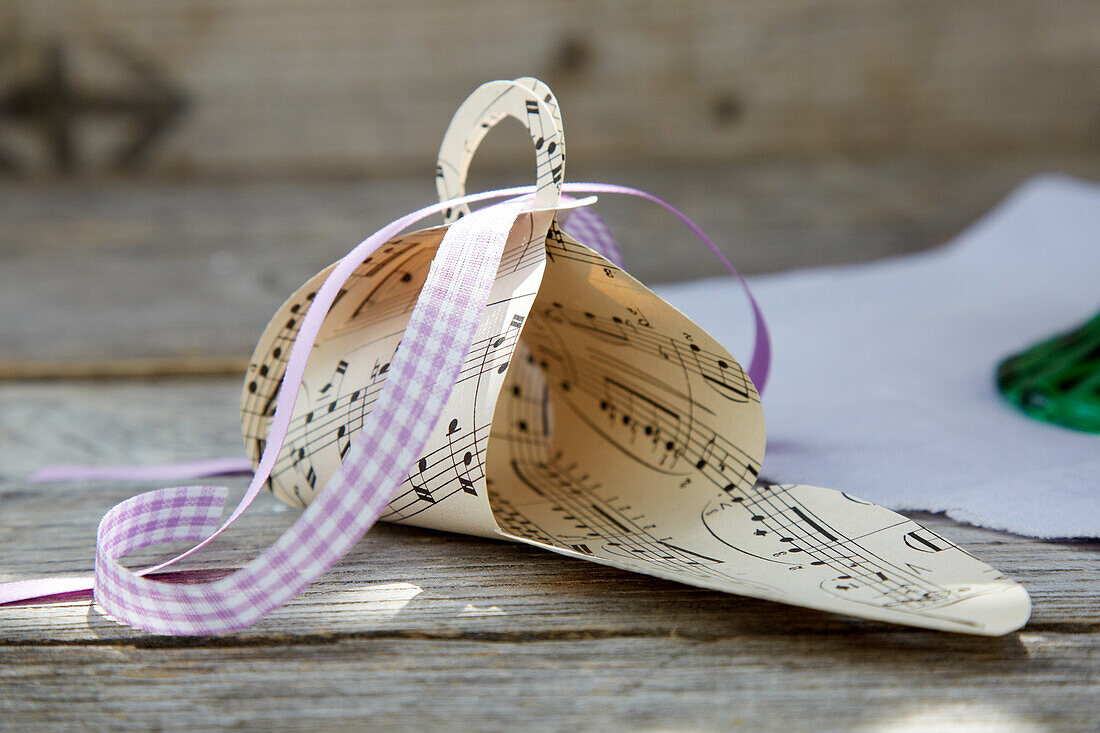 Gift box for chocolates made from sheet music and ribbon