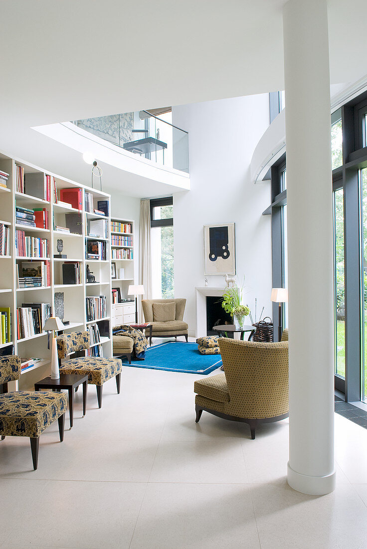 Open-plan library in modern architect-designed house with gallery level