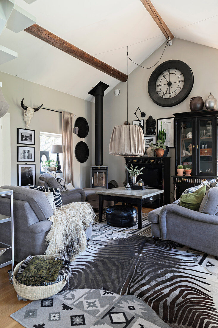 Grey sofa set and zebra-skin rug in living room