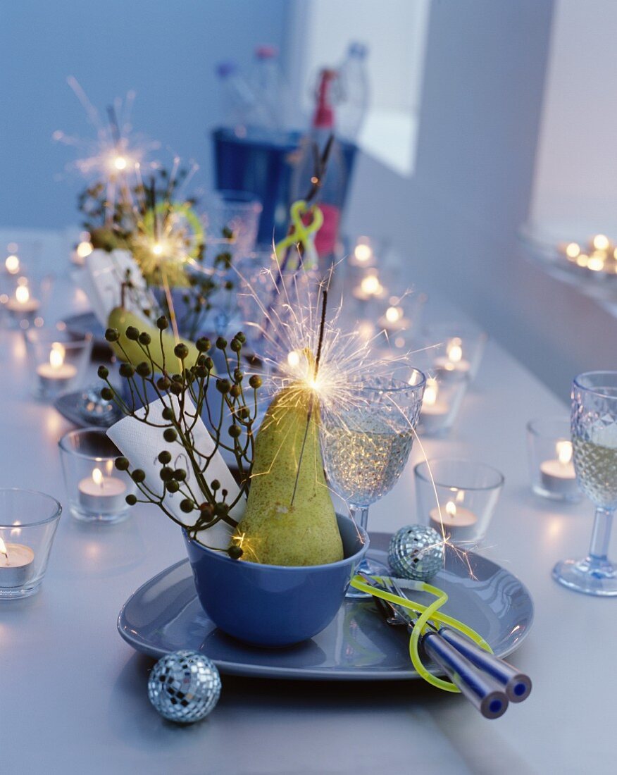 Table set with tealight holders and sparklers for New Year