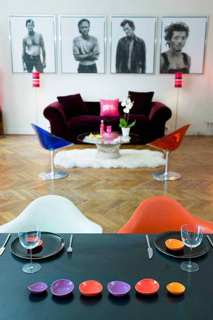 View from dining table into colourful living room with herringbone parquet floor