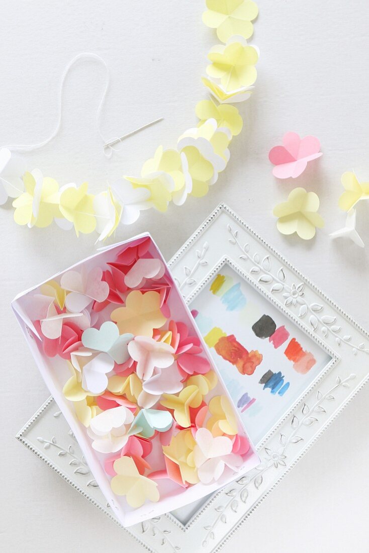 Paper flowers in box and threaded on garland