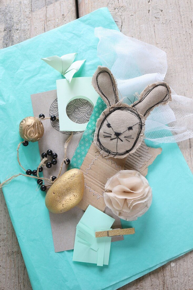 Easter mood board: fabric rabbit, gilt stone and paper
