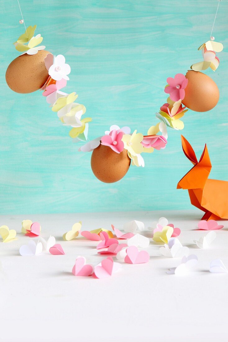 Garland of threaded paper flowers and eggs