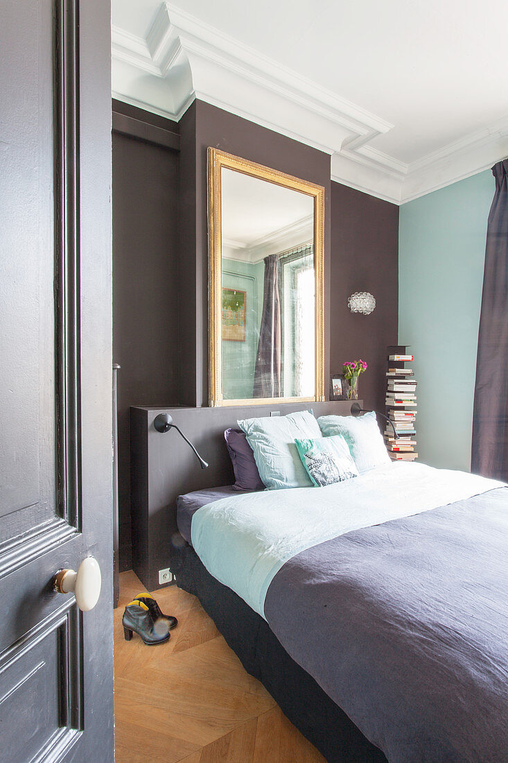 Large mirror above bed in two-tone bedroom