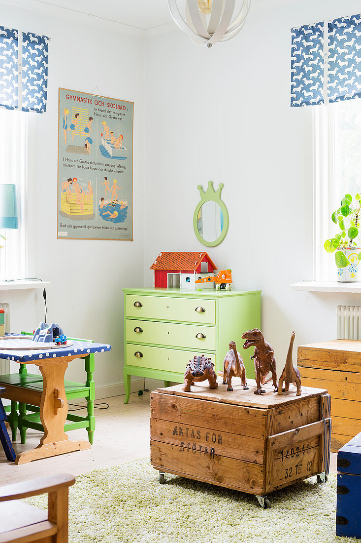 Toys on old wooden crate with castors in vintage-style child's bedroom