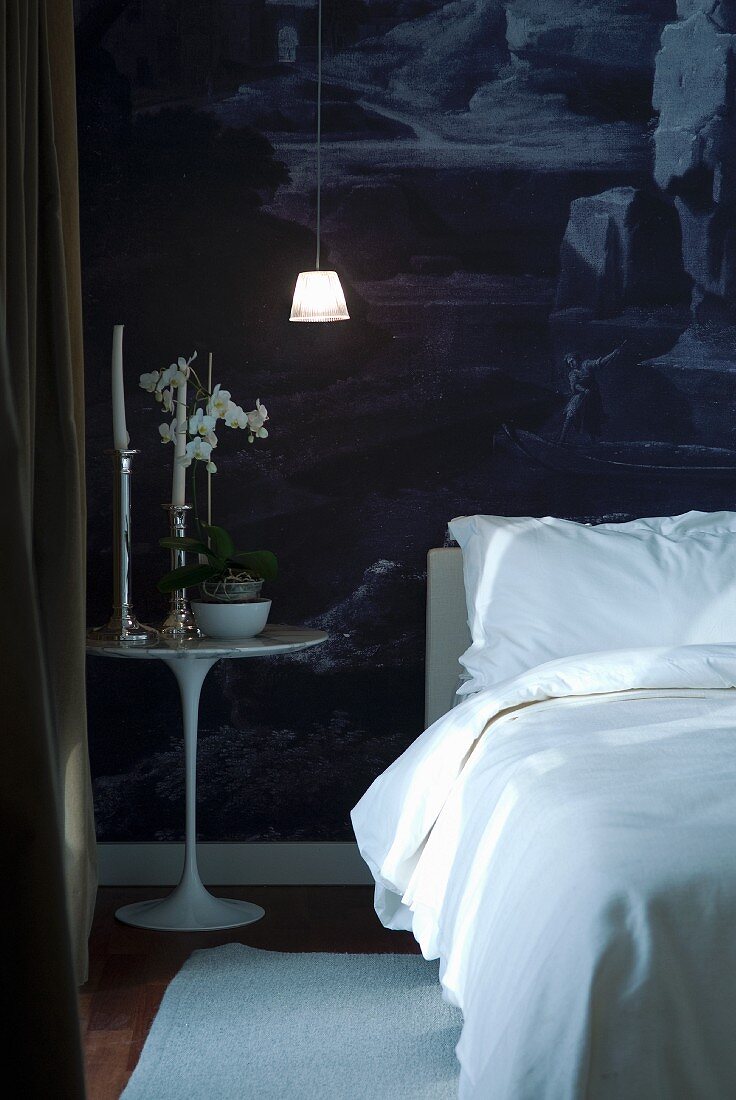 White furniture against dark wallpaper in bedroom