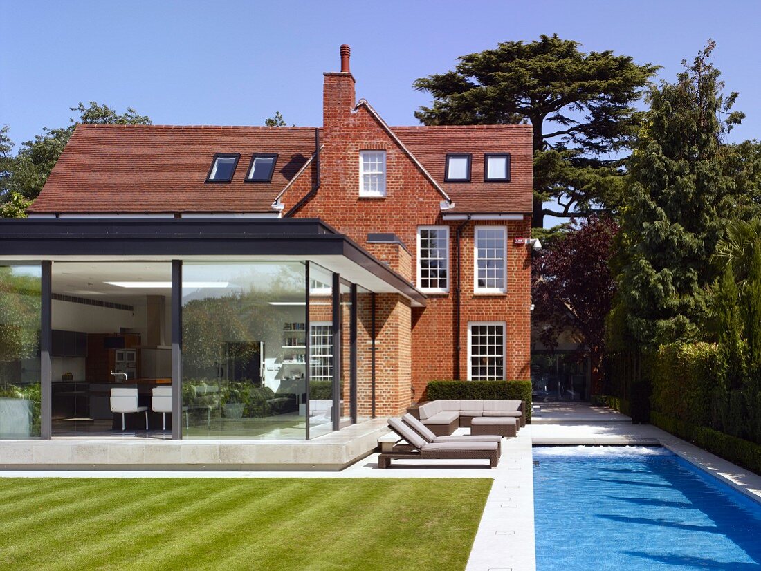 Brick house and extension with glass façades