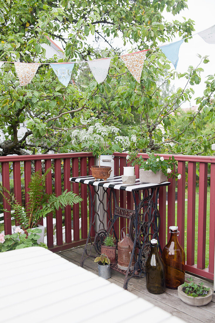 Bunting above old sewing-machine table on balcony