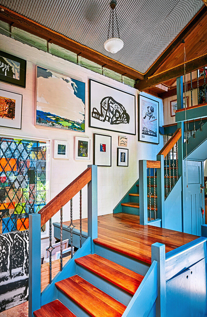 Art gallery in the stairwell with blue painted front