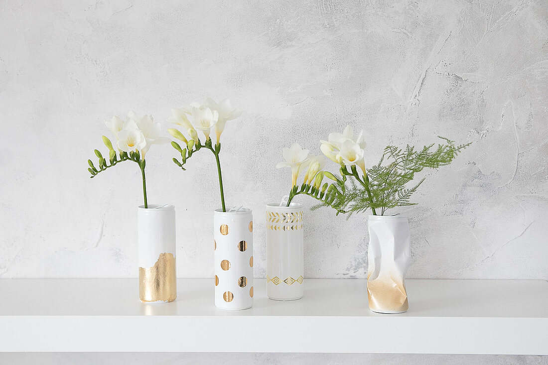 Gold and white vases hand-made from cans