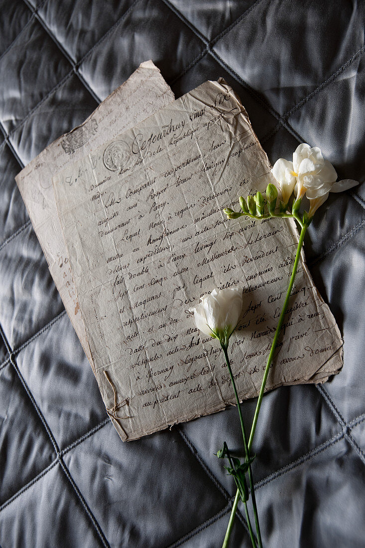 Freesia and Eustoma on old handwritten letter