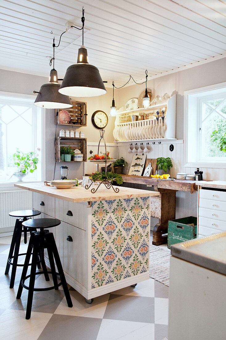 Kitchen island with wallpaper on end in Scandinavian country-house kitchen