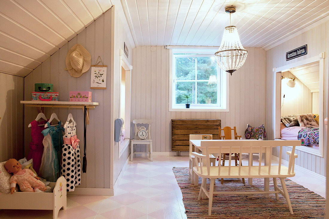 Cubby bed under sloping ceiling in child's rustic bedroom
