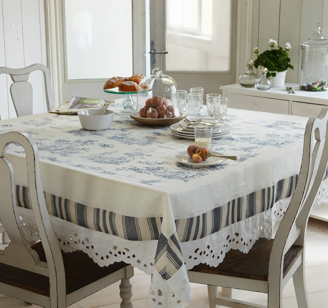 Toile de jouy tablecloth on dining table in traditional ambiance