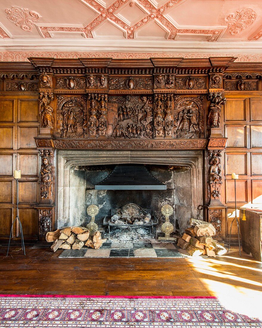 Open fireplace with enormous carved wooden surround