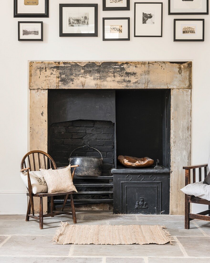 Original fireplace and antique chair on stone-flagged floor