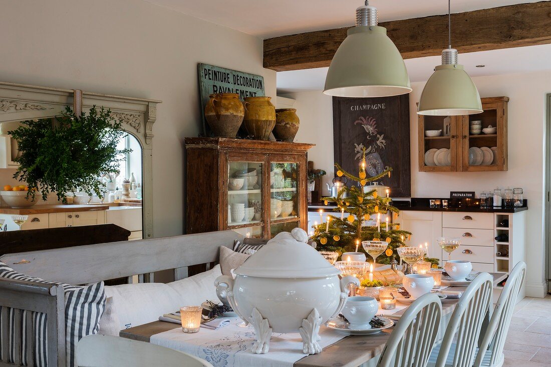 Festively set table and Christmas tree in kitchen-dining room